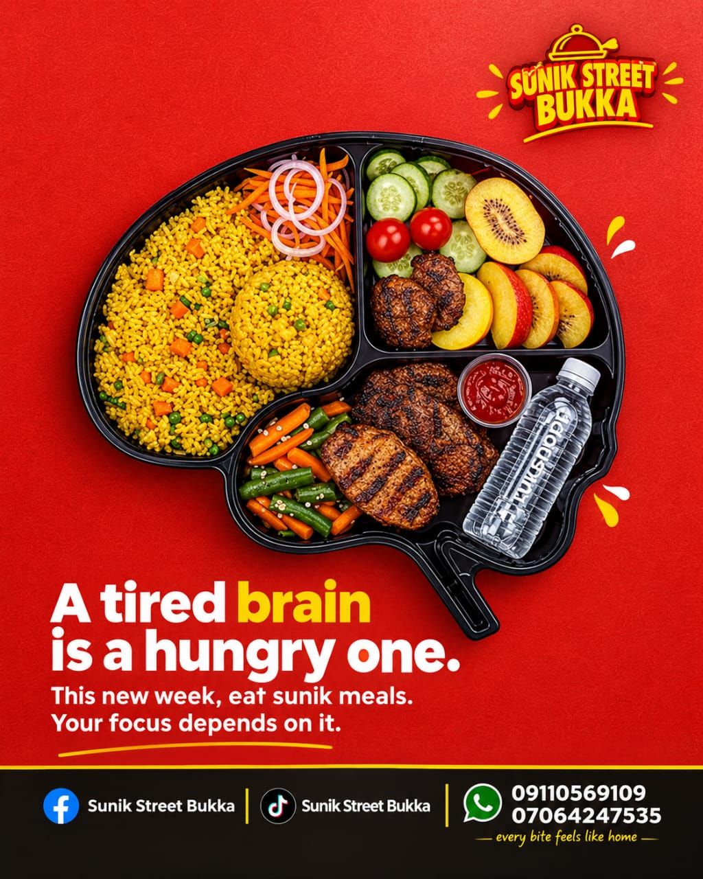 A tray of jollof rice, grilled meat, vegetables and fruit with bottled water