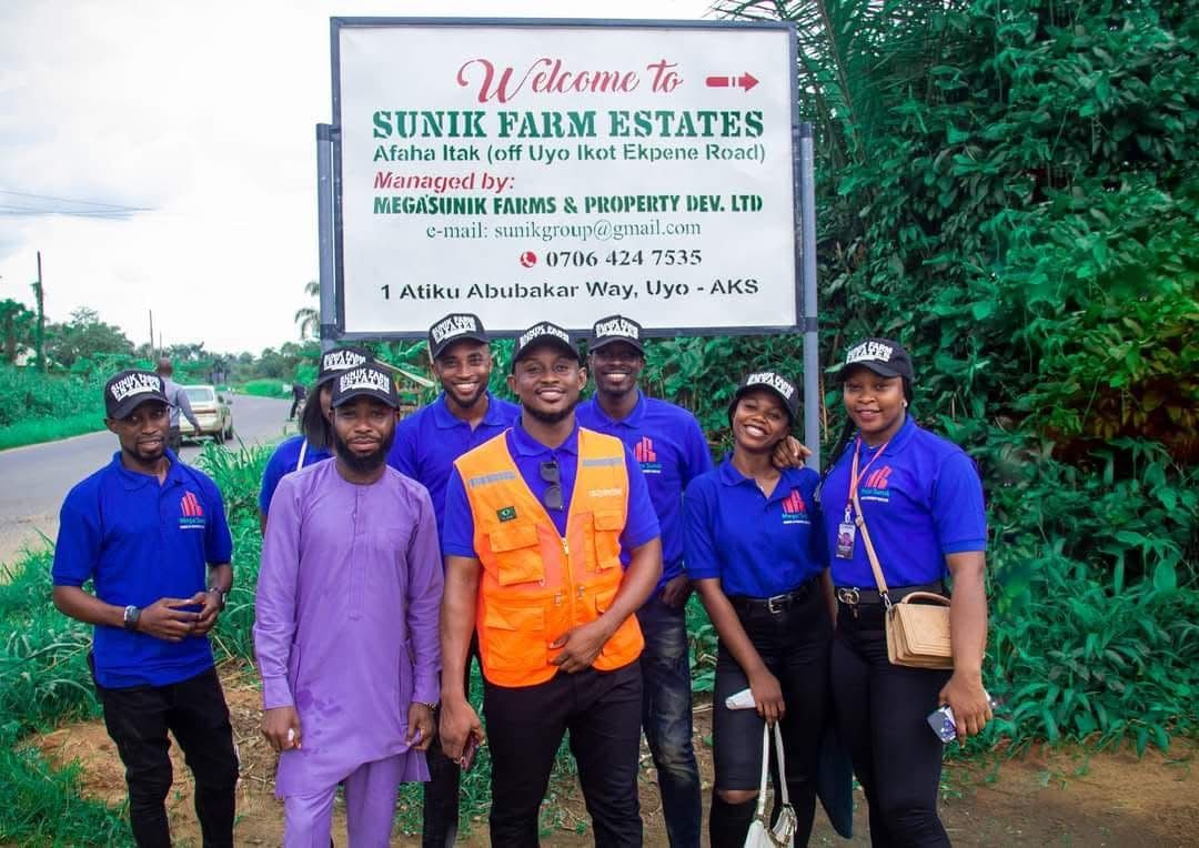 The Sunik team at the Sunik Farm Estates signboard